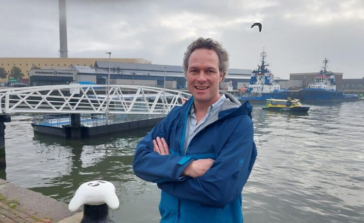 Male stood next to a waterway in Rotterdam