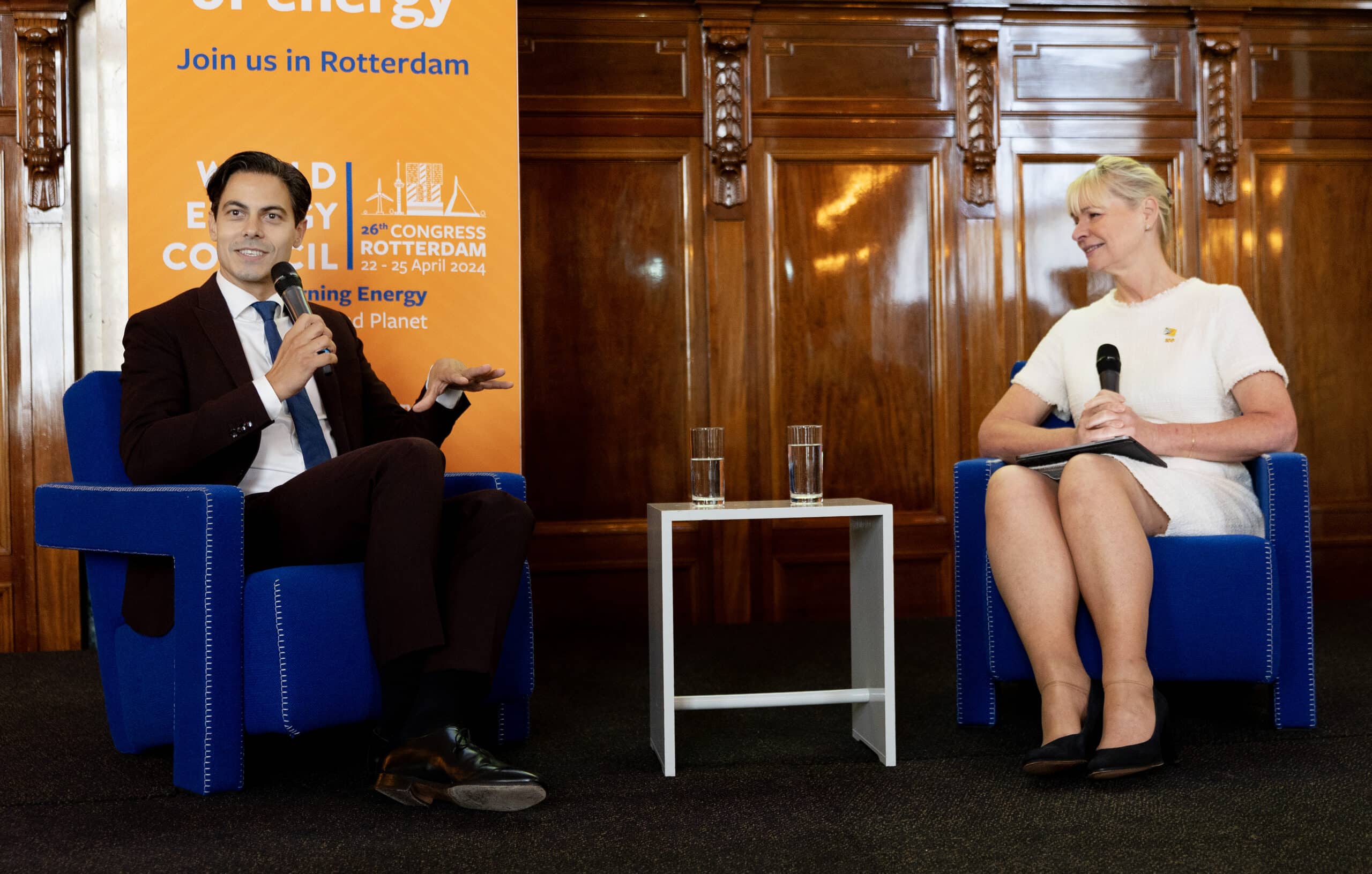 Rob Jetten and Angela Wilkinson sat on blue chairs in discussion